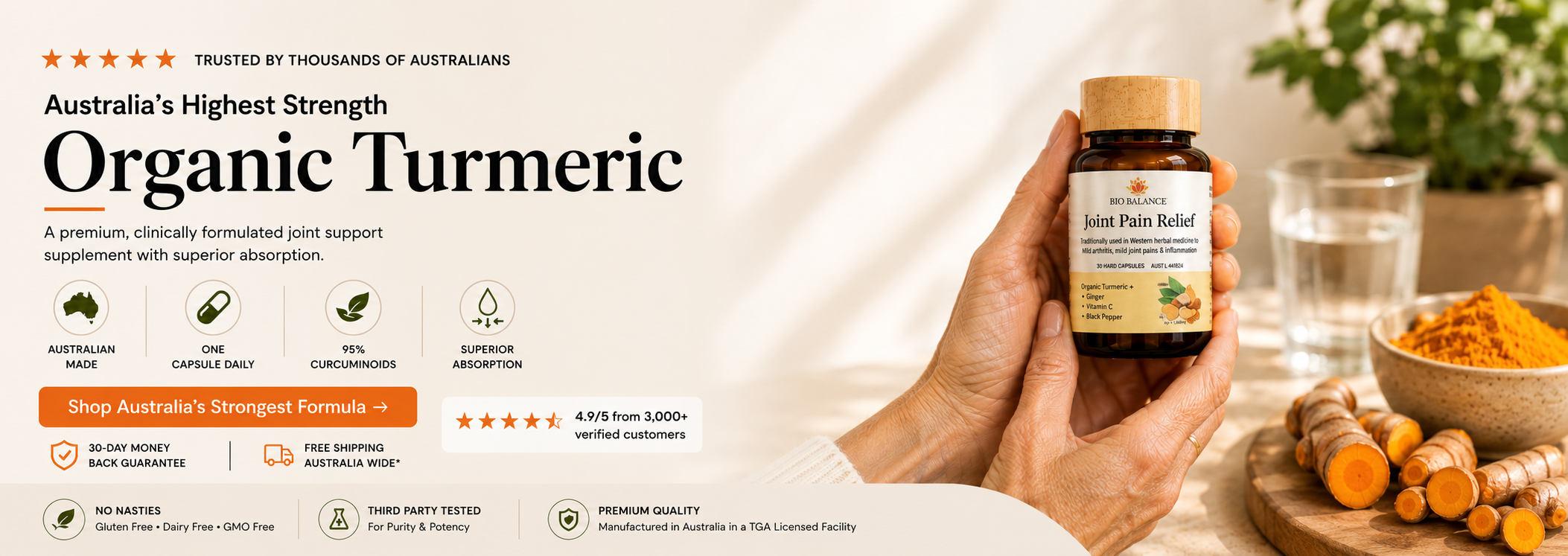 A hand holds a small amber bottle labeled Joint Pain Relief next to a bowl of orange turmeric powder and turmeric roots on a wooden board, with marketing text about organic turmeric on a light beige background.